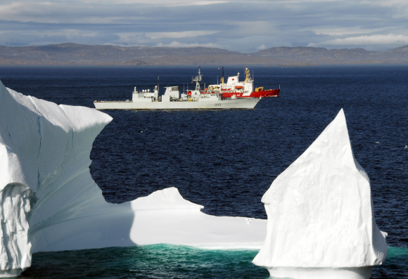 HMCS Toronto and the Canadian Coast Guard Ship (CCGS) Pierre Radisson sail past an iceberg in the Hudson Strait off the coast of Baffin Island. Photo by: Sergeant Kevin MacAulay